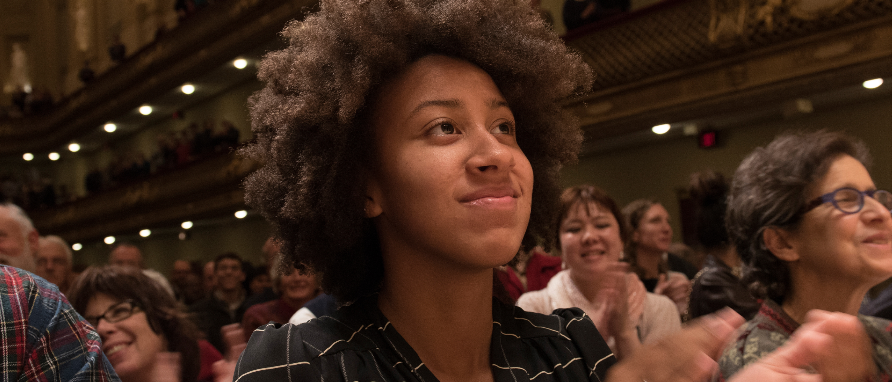 Young Black female audience member smiling