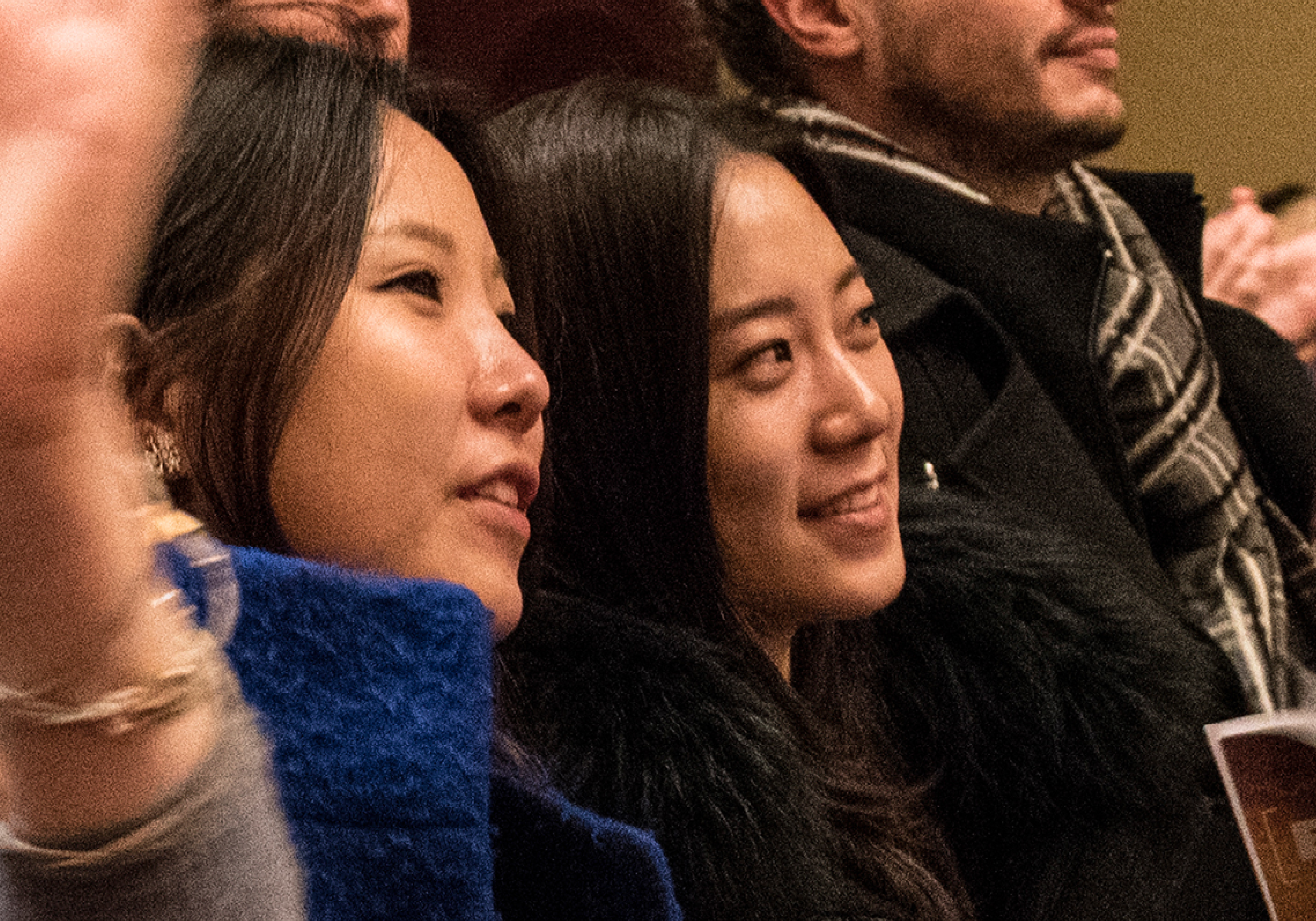 Young female audience members smiling