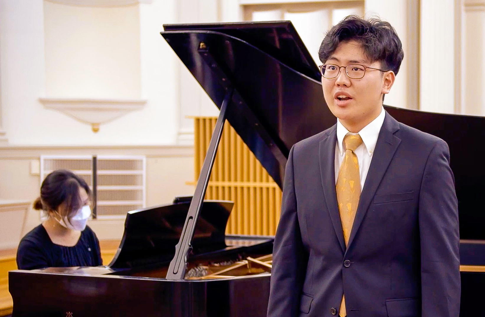 man in a suit singing