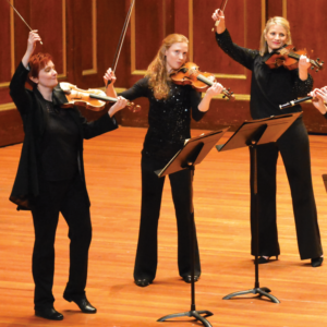 three women playing violin